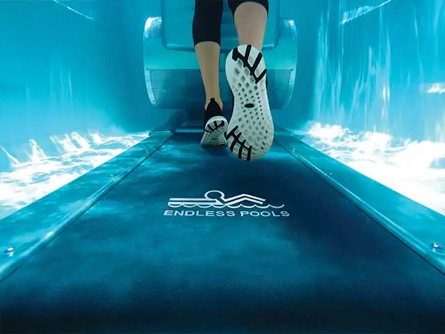 Detail shot of feet running on a endless pools underwater treadmill