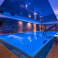 An indoor swimming pool built in a large basement.
