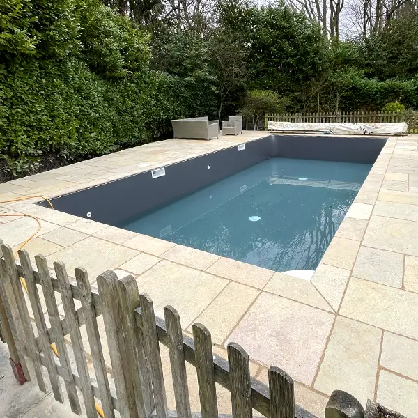 A newly refurbished swimming pool with freshly laid patio.